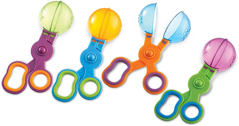 Four colorful plastic scissors with scoops in green, yellow, blue, and pink.