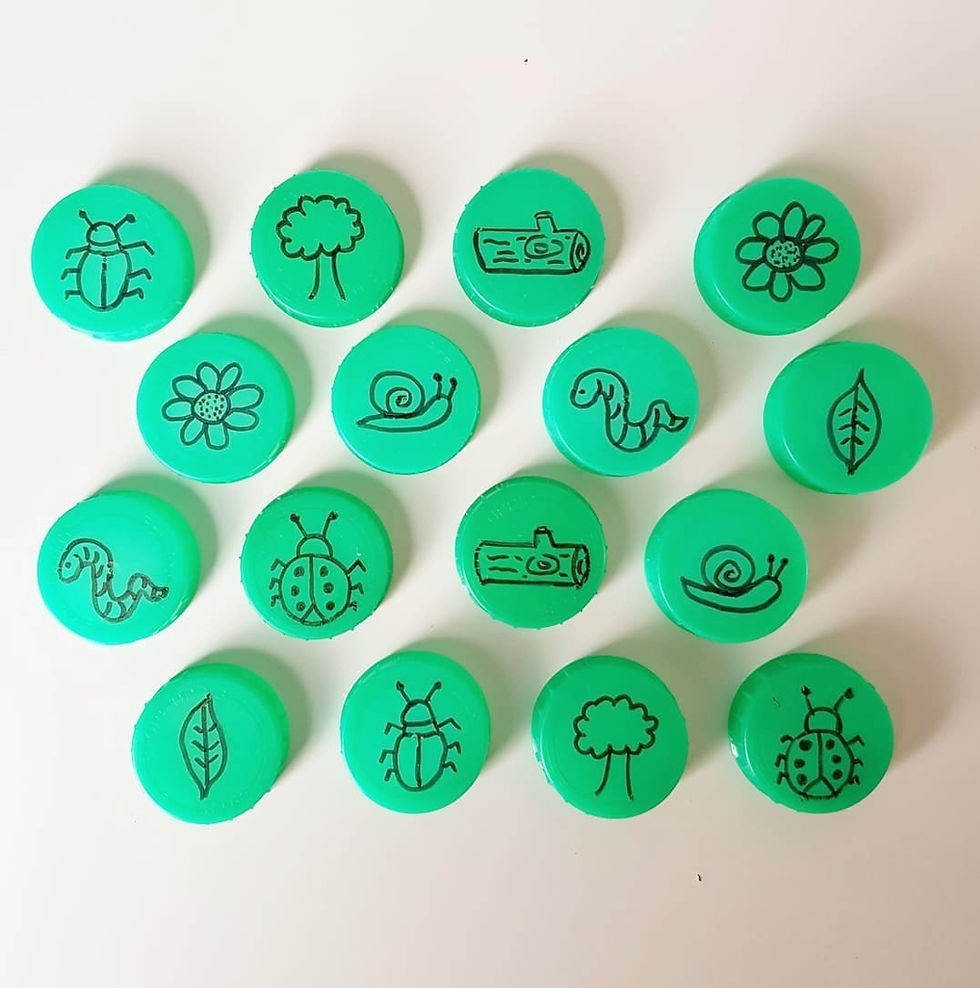Green bottle caps with black line drawings featuring insects, leaves, flowers, trees, and logs, arranged on a white background.