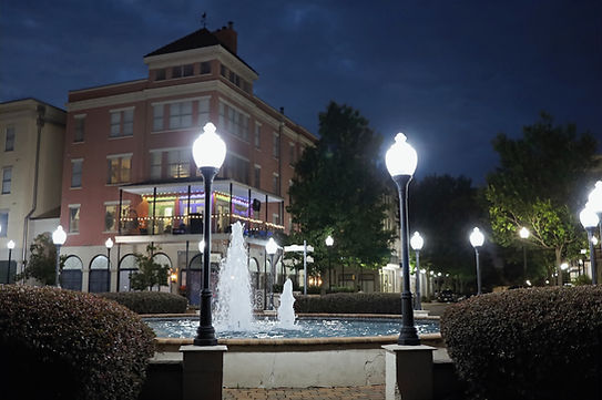 Night shot of Fountain in plaza with globe lights