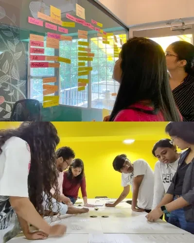 In the above photo students are working using post it notes and creating user flows. In the below photo another team is working on information architecture.