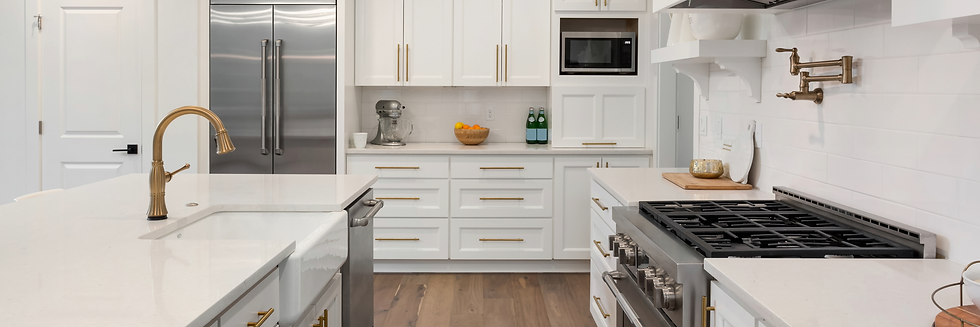 Modern white kitchen remodeling project with custom cabinetry, quartz countertops, and stainless steel appliances completed b