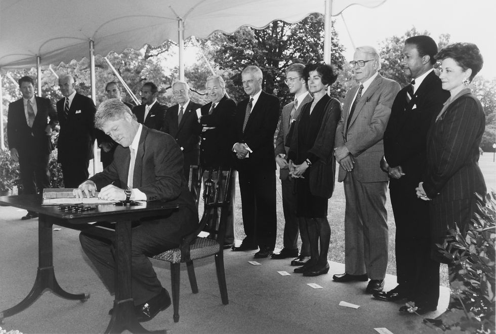 President Bill Clinton signing the National Voter Registration Act of 1993 (Motor Voter Act), as Vice-President Albert Gore and notable members of Congress look on.