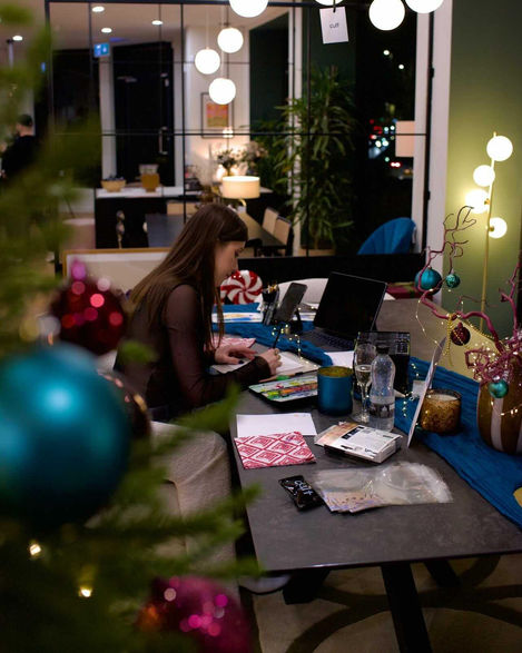 a woman sits at a table with an ipad on it