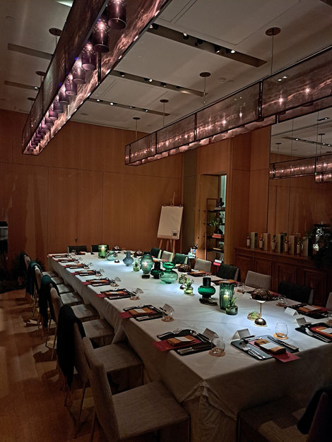 a long VIP dining table with candles and plates on it