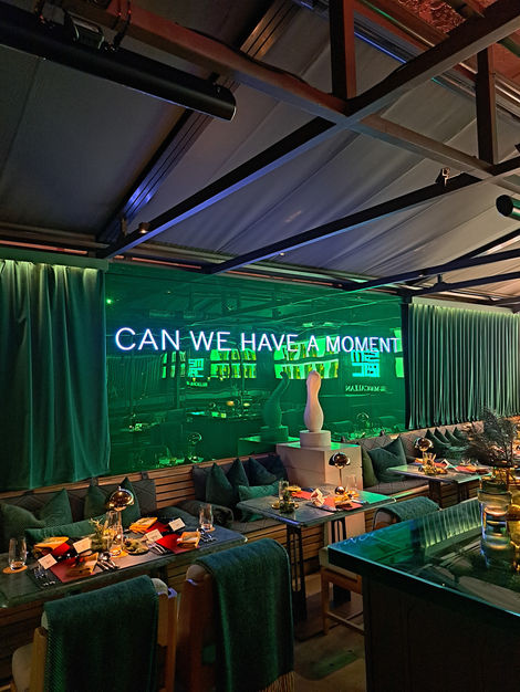 a restaurant with a sign that says " can we have a moment "