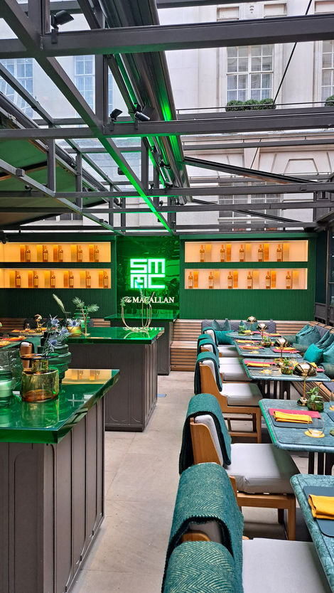 a restaurant with a green sign that says macallan
