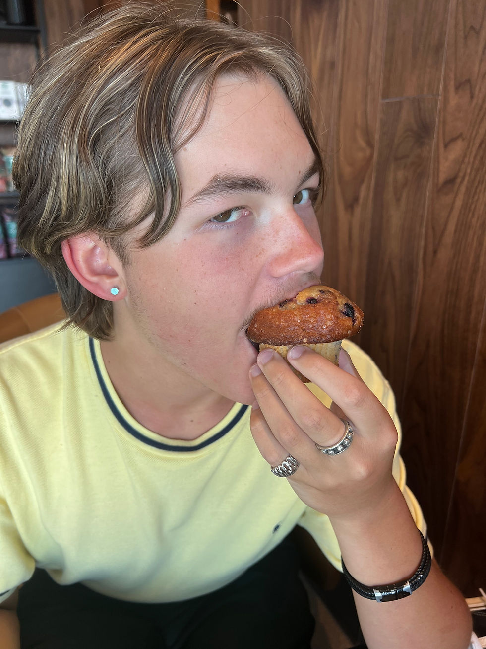 Aidan eating a muffin.