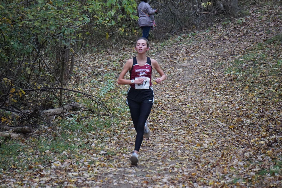 Peyton couch running at the cross country conference