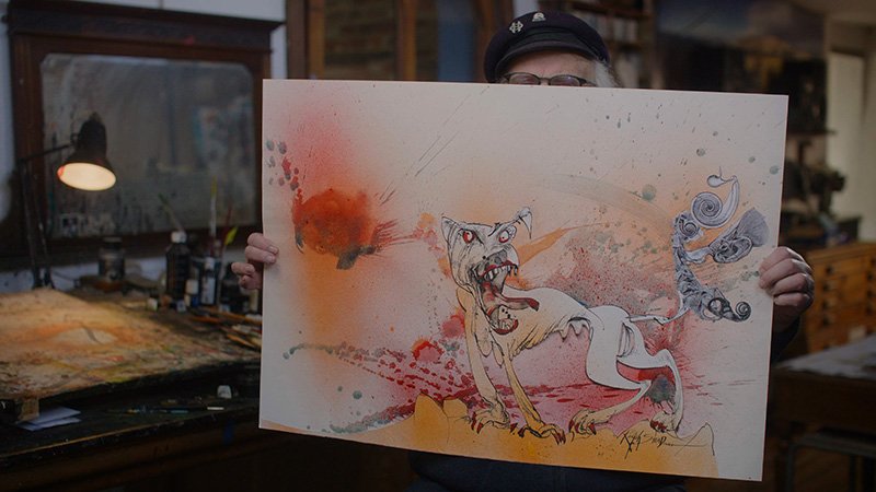 Ralph Steadman holds the original Flying Dog Raging Bitch artwork