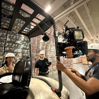 Camera rigged to the side of a fork lift, wide shot