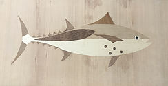 A marquetry illustration of a fish made from several types of wood veneer