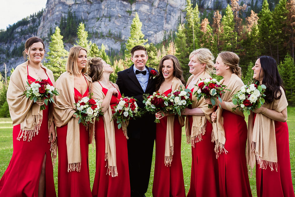 Groom and bridesmaids having fun at Tunnel Mountain in Banff