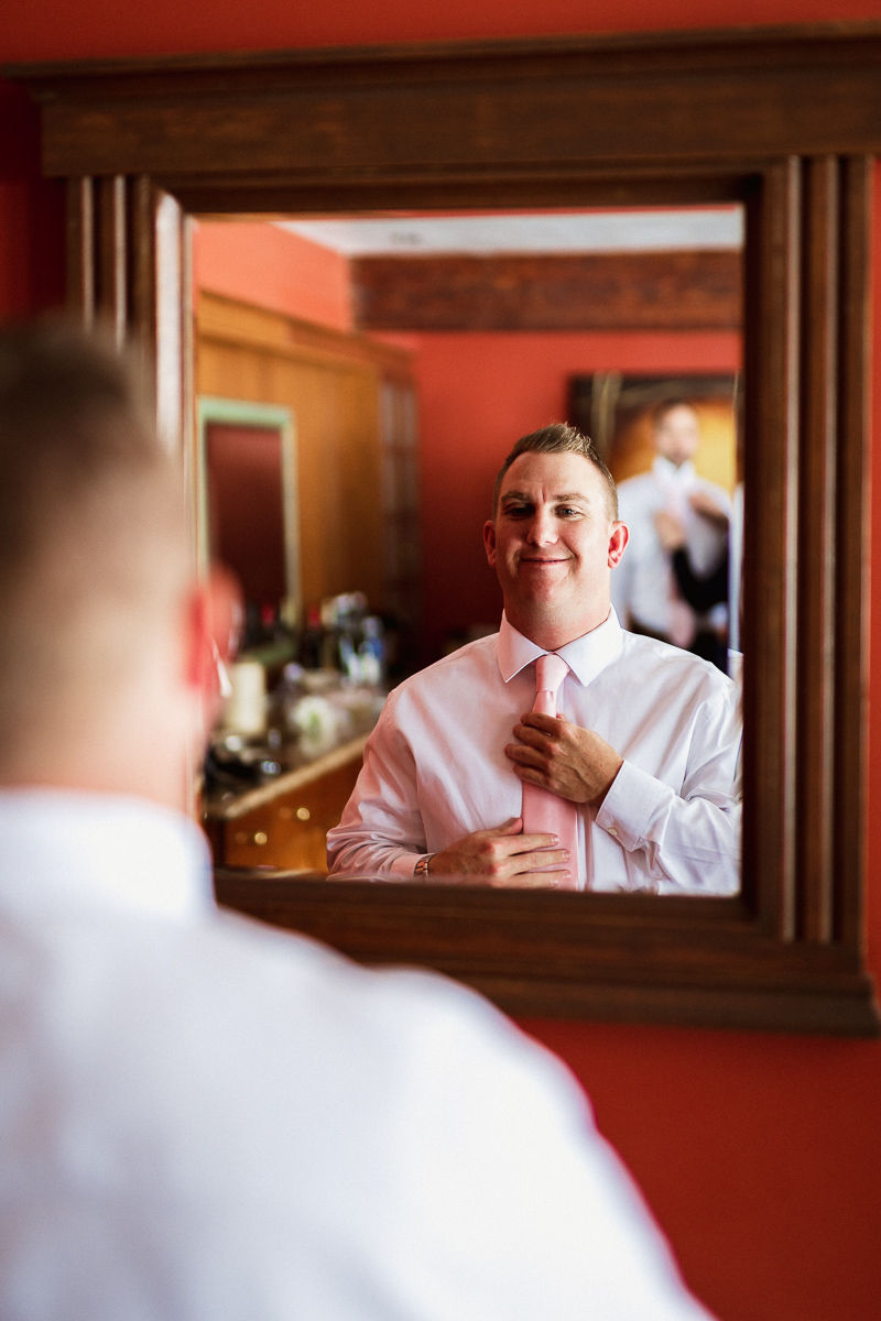 Emerald Lake wedding photographer capturing groom getting ready adjusting tie