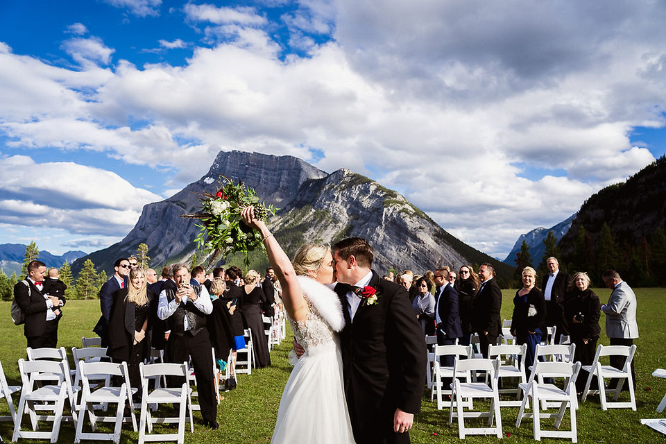 Celebrating with a first kiss at their Tunnel Mountain wedding in Banff