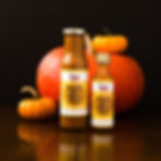 Camella's Kitchen sauces in front of pumpkins and a black background
