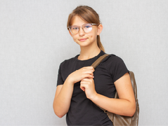 Young girl wearing glasses geared to go to school.