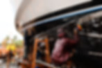 Ratanachai Shipyard's wet sanding the hull surface for antifouling using orbital air sanders