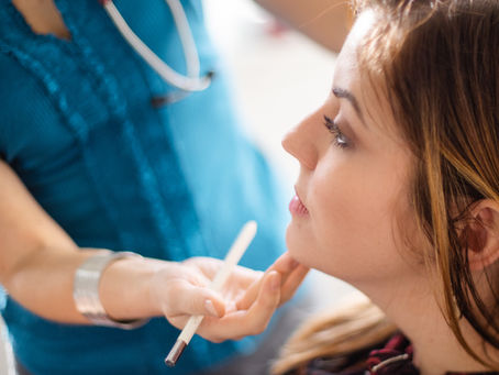 Dr. Helena Zurekova assessing a patient’s botox treatment results at a naturopathic clinic in Richmond BC.