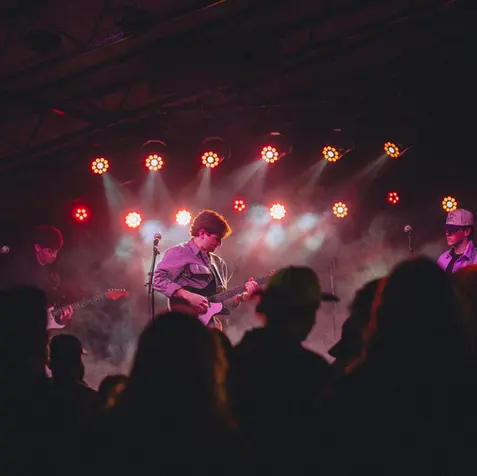 Musician plays guitar on stage at Billboard SXSW After Party