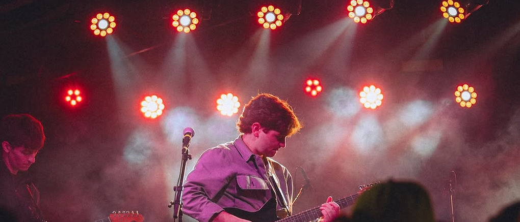 A musician on stage at the Billboard SXSW after party, run phone-free with lockable phone pouches