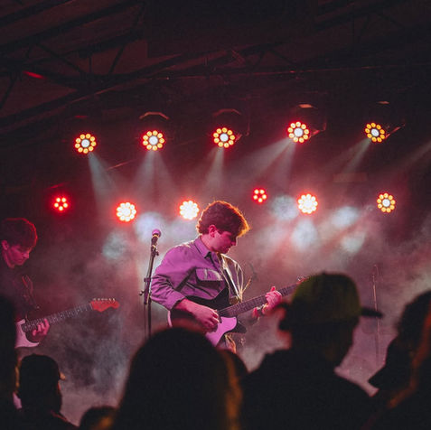 Musician playing electric guitar on stage at SXSW.