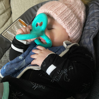 baby chewing on a Lovevery silicone triple teether