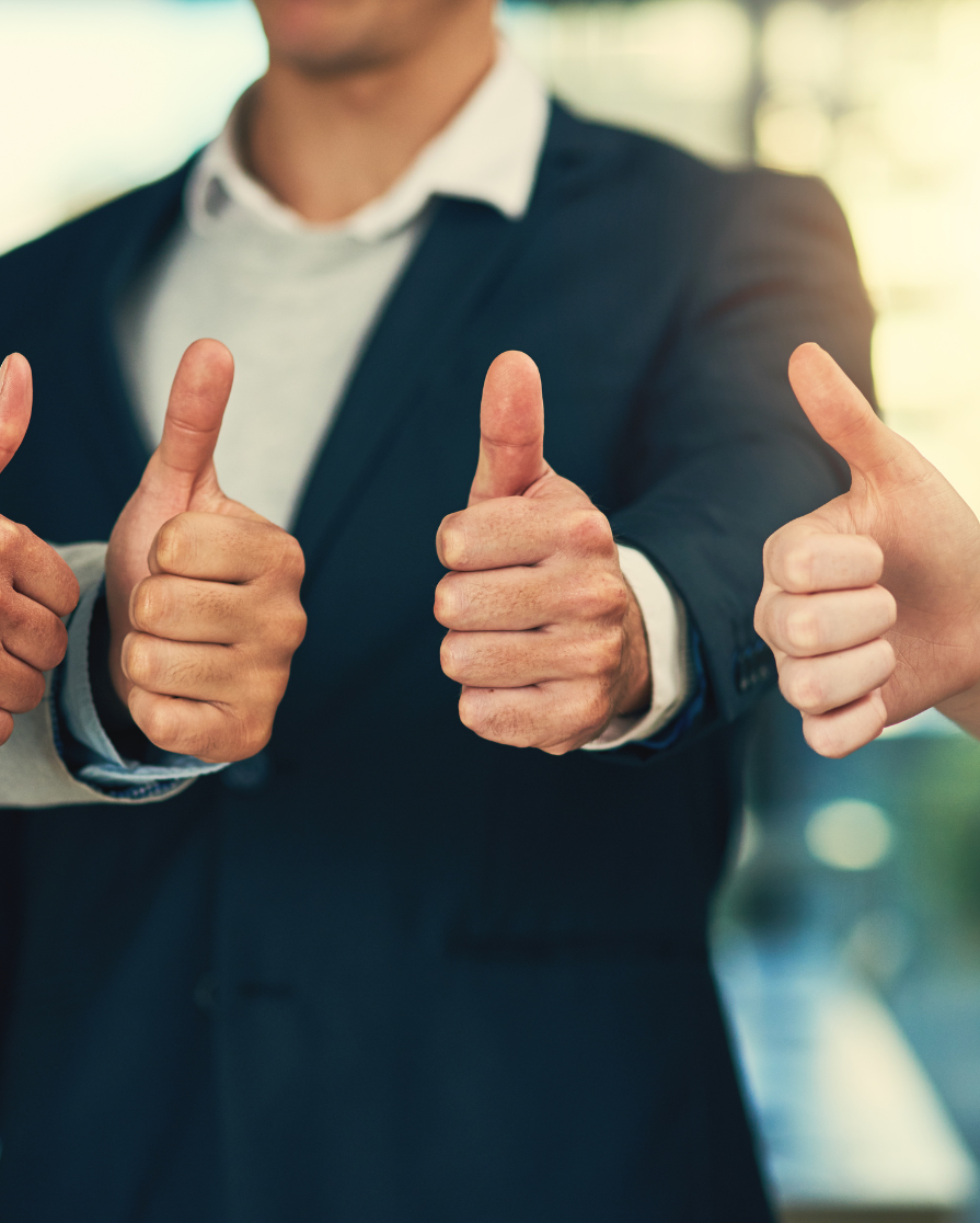 men in suits giving a thumbs up