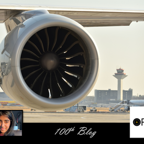 Close-up of a jet engine at an airport with control tower in background. Inset: smiling person. Text: "100th Blog" and "OFLY" logo.