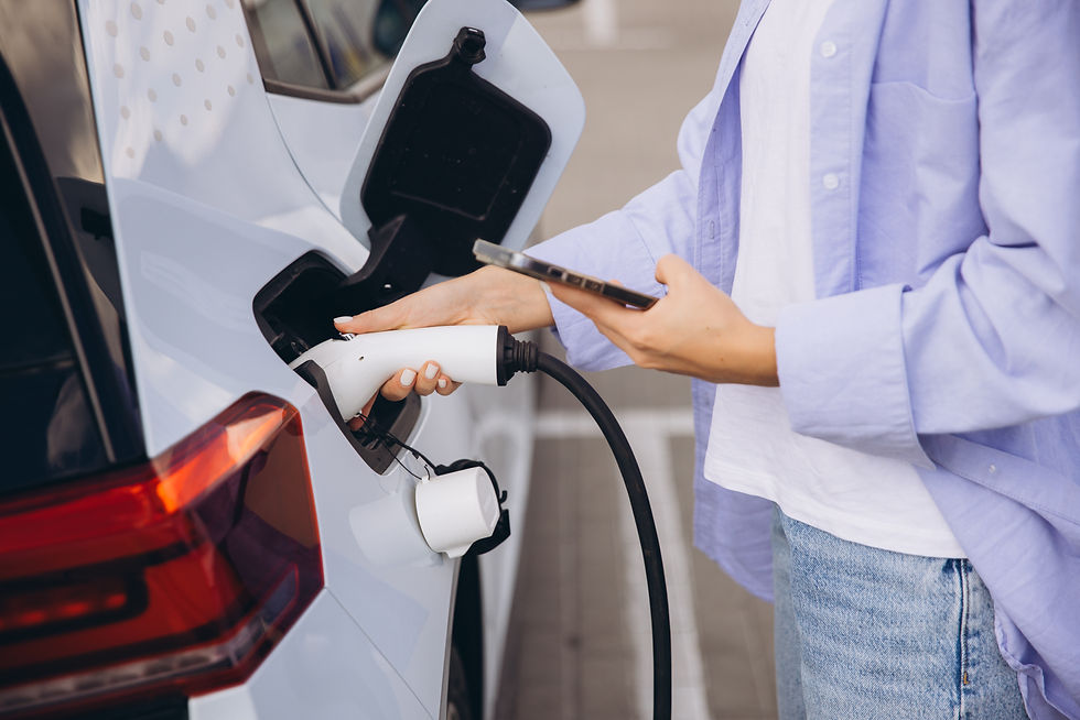 A woman charging an electric vehicle 