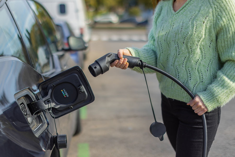 Woman in green sweater using public charge points