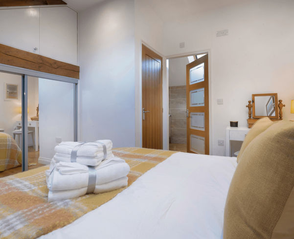 double bedroom with fresh towels in Lake District holiday cottage Cumbria