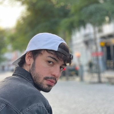 Portrait of Steve Biewer outdoors on a city street, wearing a backwards cap