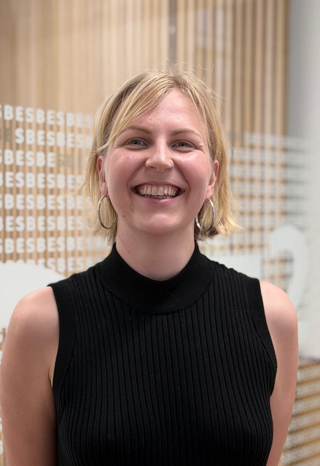 Portrait of Nea Saarreharju smiling, wearing a black sleeveless top