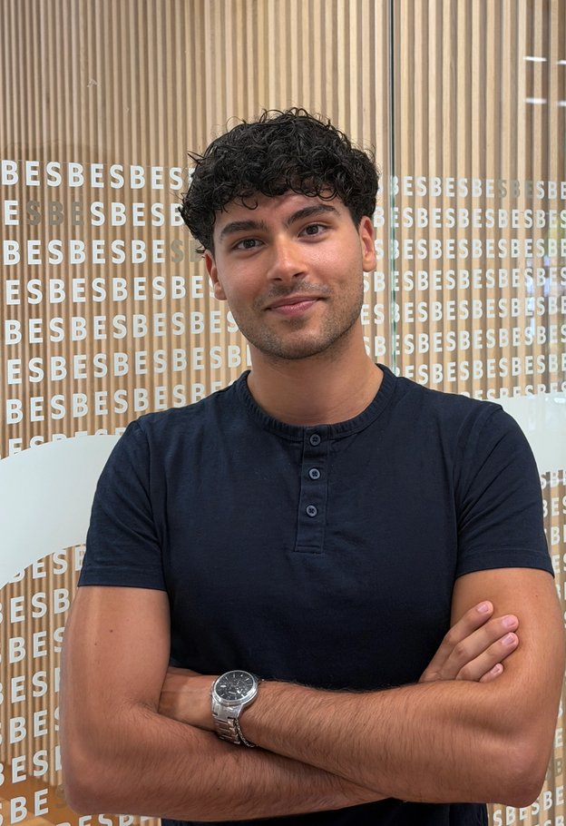 Portrait of Ilias Massignan with arms crossed, wearing a navy T-shirt