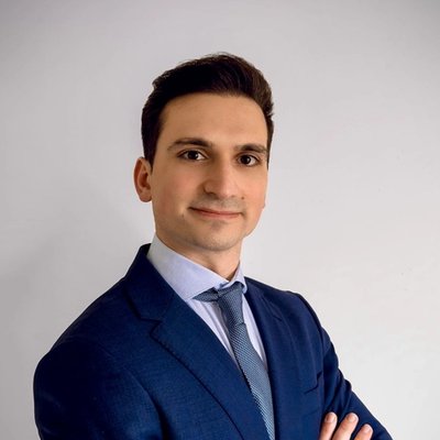 Portrait of David Grigorjan in a navy suit and tie