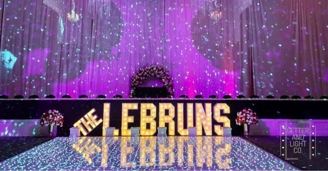 Giant wedding marquee letters spelling "THE LEBRUNS", by Letter and Light Co, now offering marquees for Des Moines weddings and events