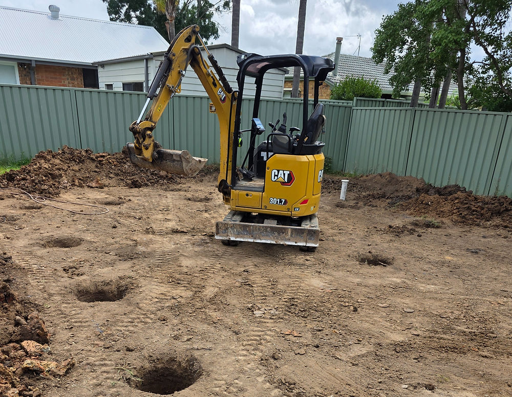 Excavator digging holes for a new project