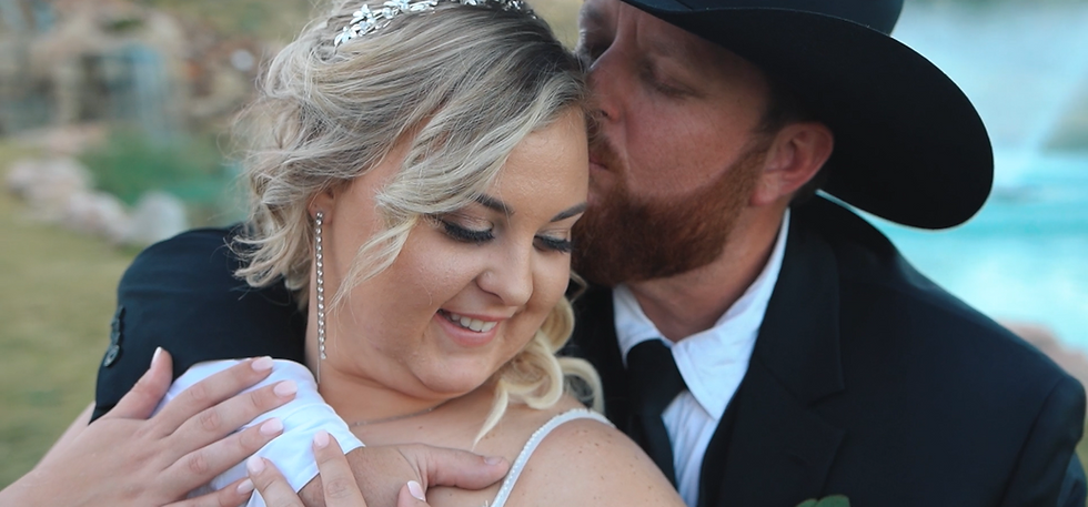 the bride and groom sharing a moment at covered bridge venue in Springtown, Texas in the wedding film by the best videographer in Dallas, Texas 