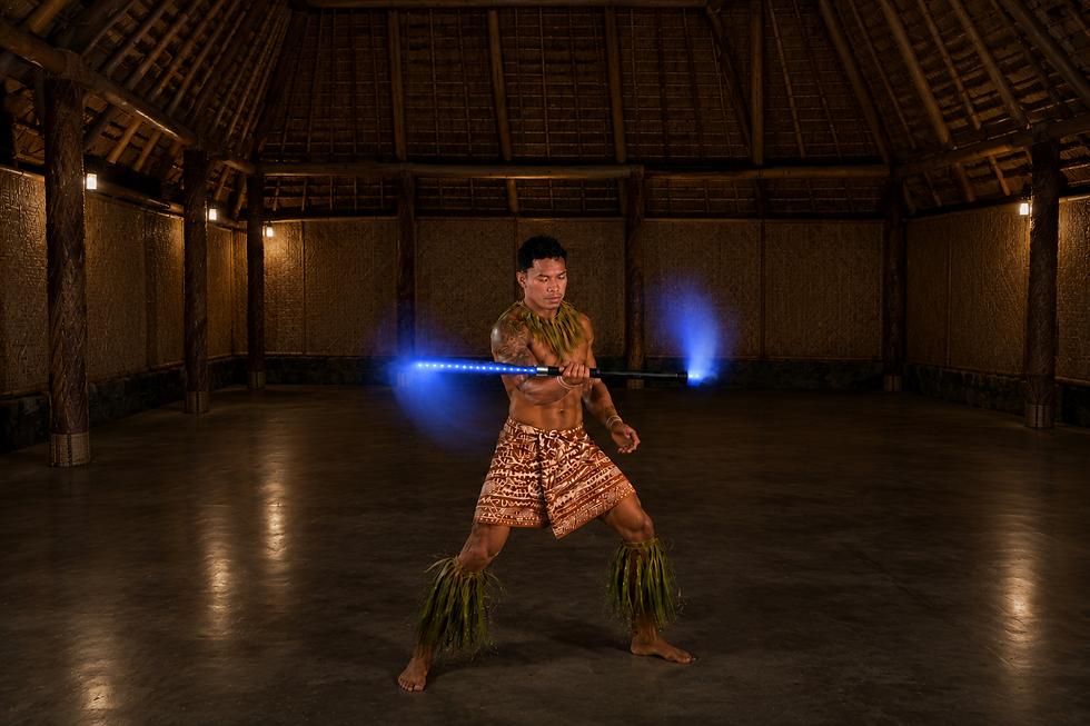 Polynesian man spinning the Sulu Vili LED Fire Knife indoors