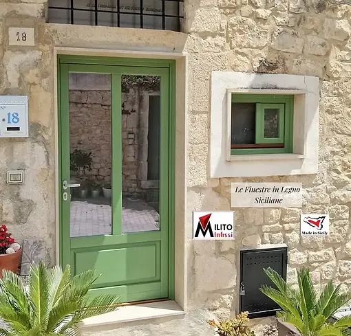 Bespoke Mediterranean green wooden front door and matching window for an authentic rustico restoration in Sicily.
