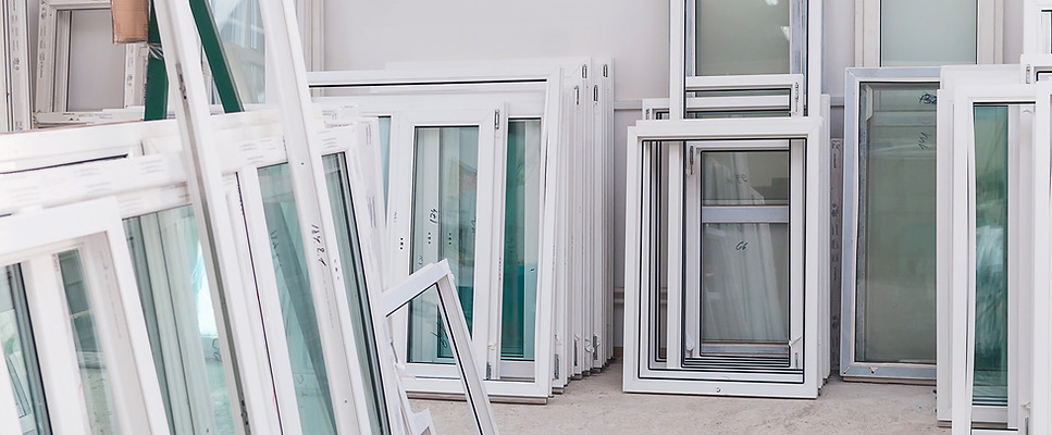 New windows leaning against a wall