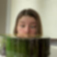 girl peeking out from cake