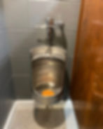 Custom stainless steel keg-style urinal and commercial flush valve installation completed by Asmann Corp.