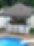 Custom covered poolside bar and outdoor entertainment area by Asmann Corp.