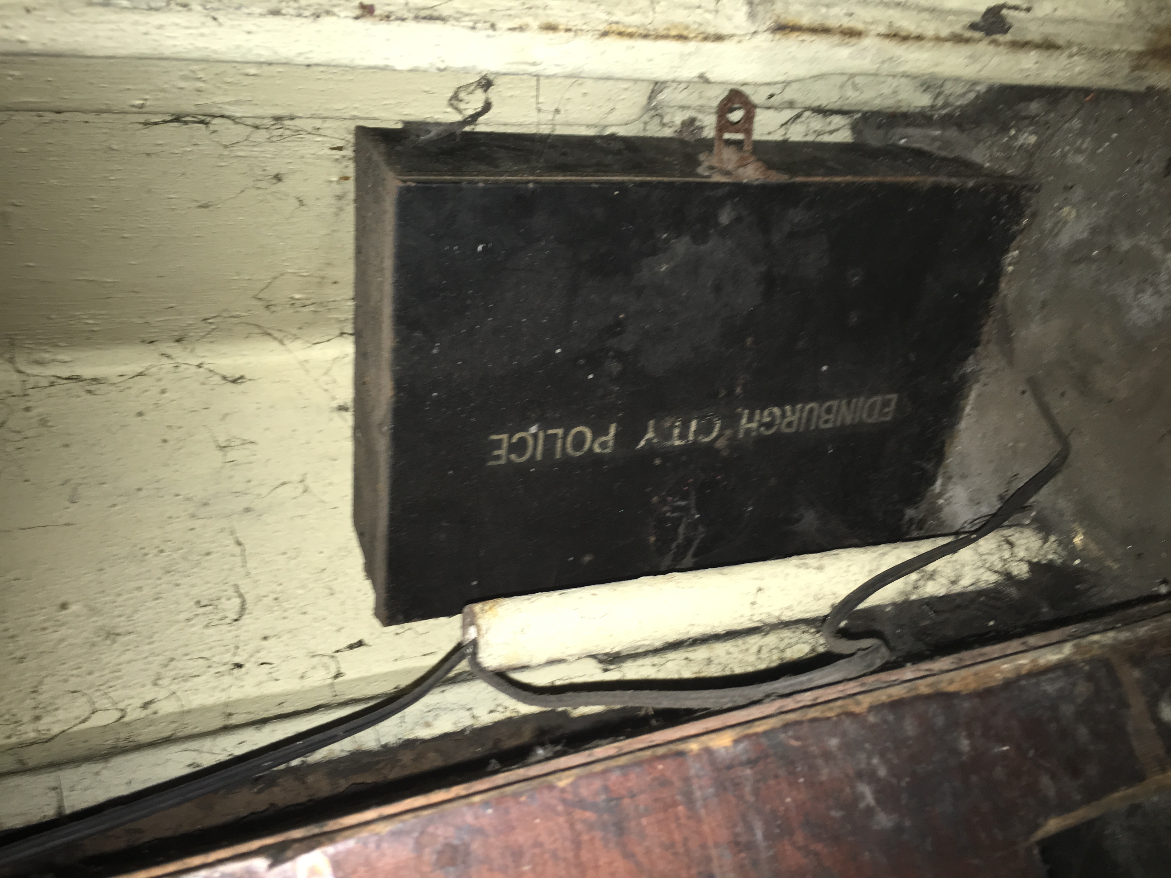 Black tin box under desk