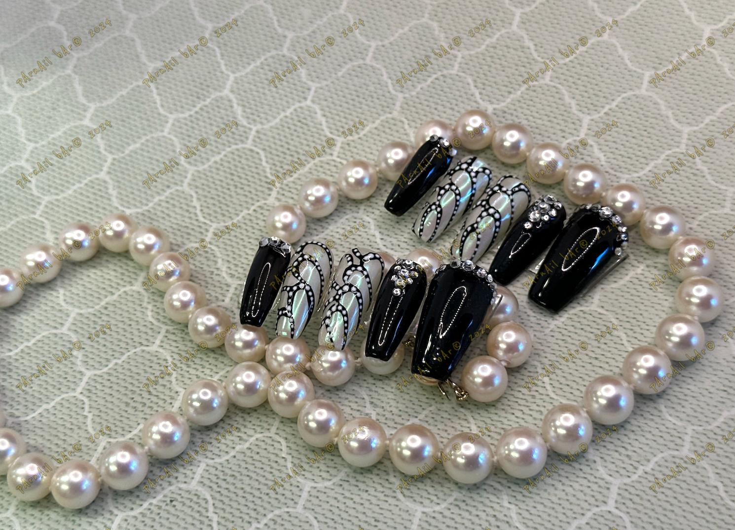 Black and white press-on nails with pearls and rhinestones