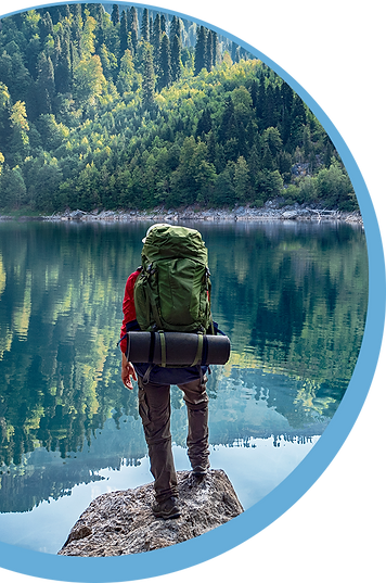 A hiker looking out over the water ready to take the journey.