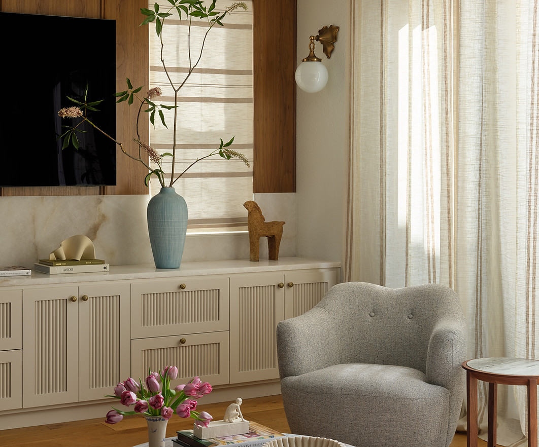 Living room media unit with fluted cabinetry and walnut paneling.