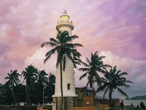 Galle lighthouse shown against a purple sunset