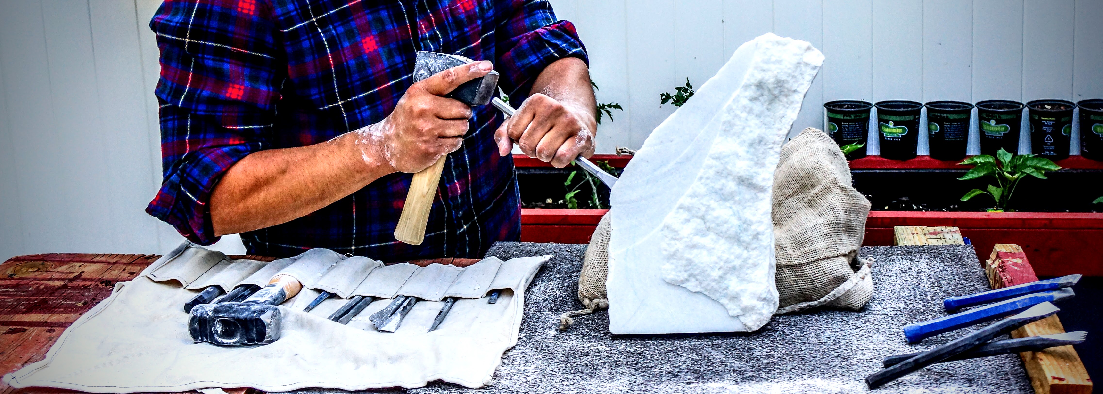 Utah sculptor Byron Ramos working on a Utah marble stone sail sculpture